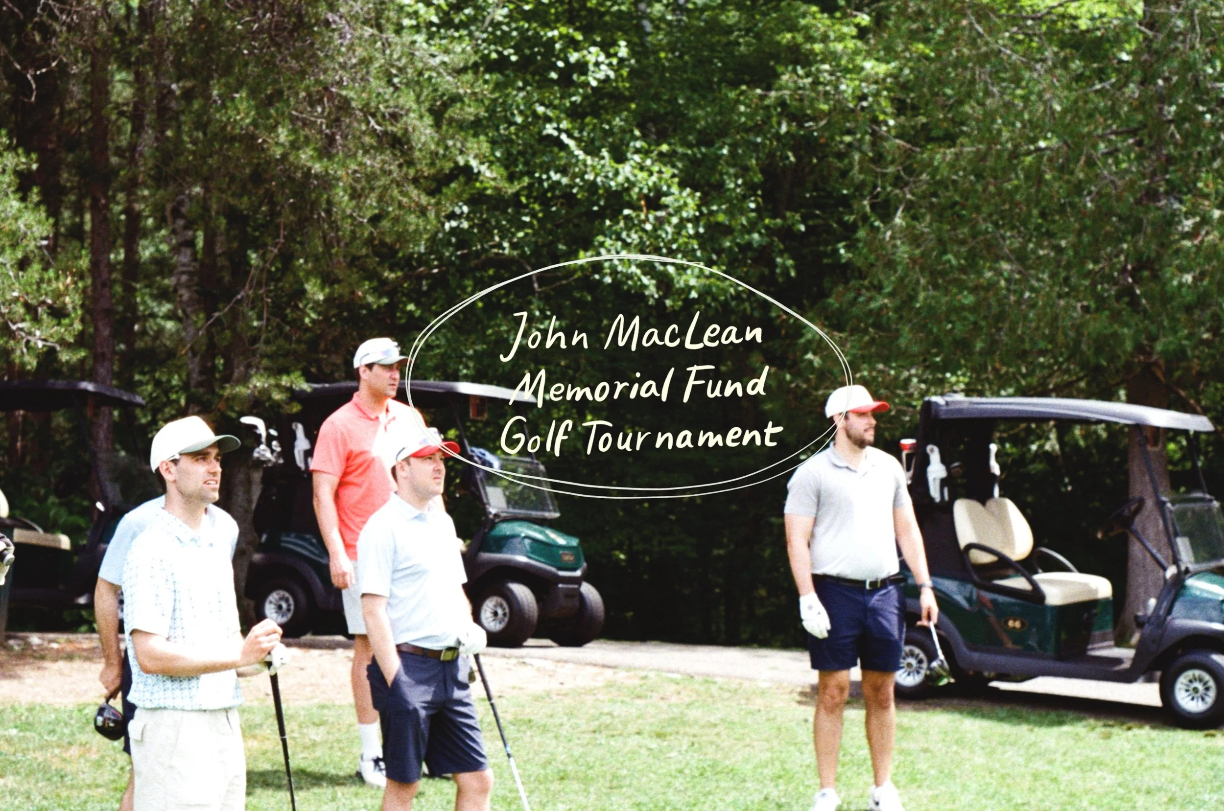 A group of men participating in the John MacLean Memorial Fund Golf Tournament, standing outdoors near golf carts, with trees in the background.