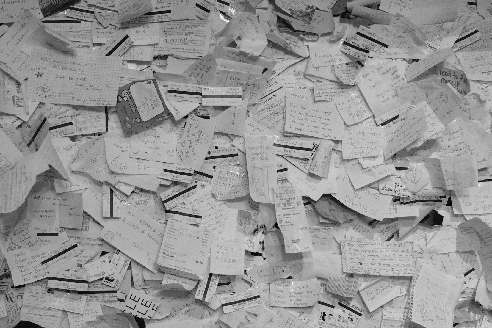 Large pile of papers in all shapes and sizes with handwriting all over them, signifying a messy working environment