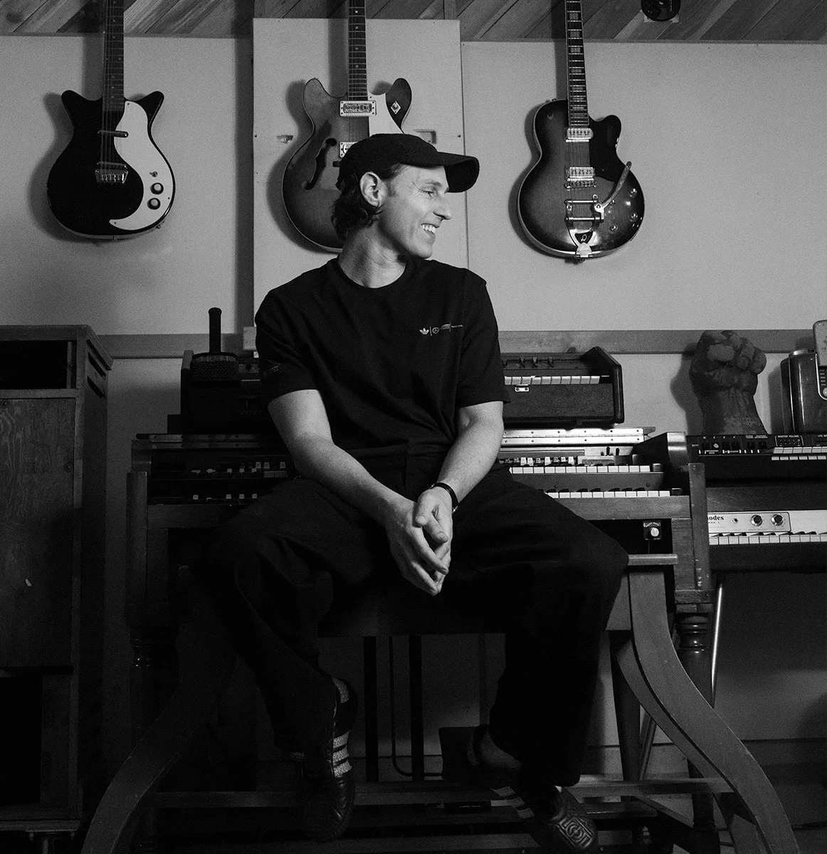 Electronic musician and producer, FENRA, in his music studio in front of guitars and  A B-3 organ