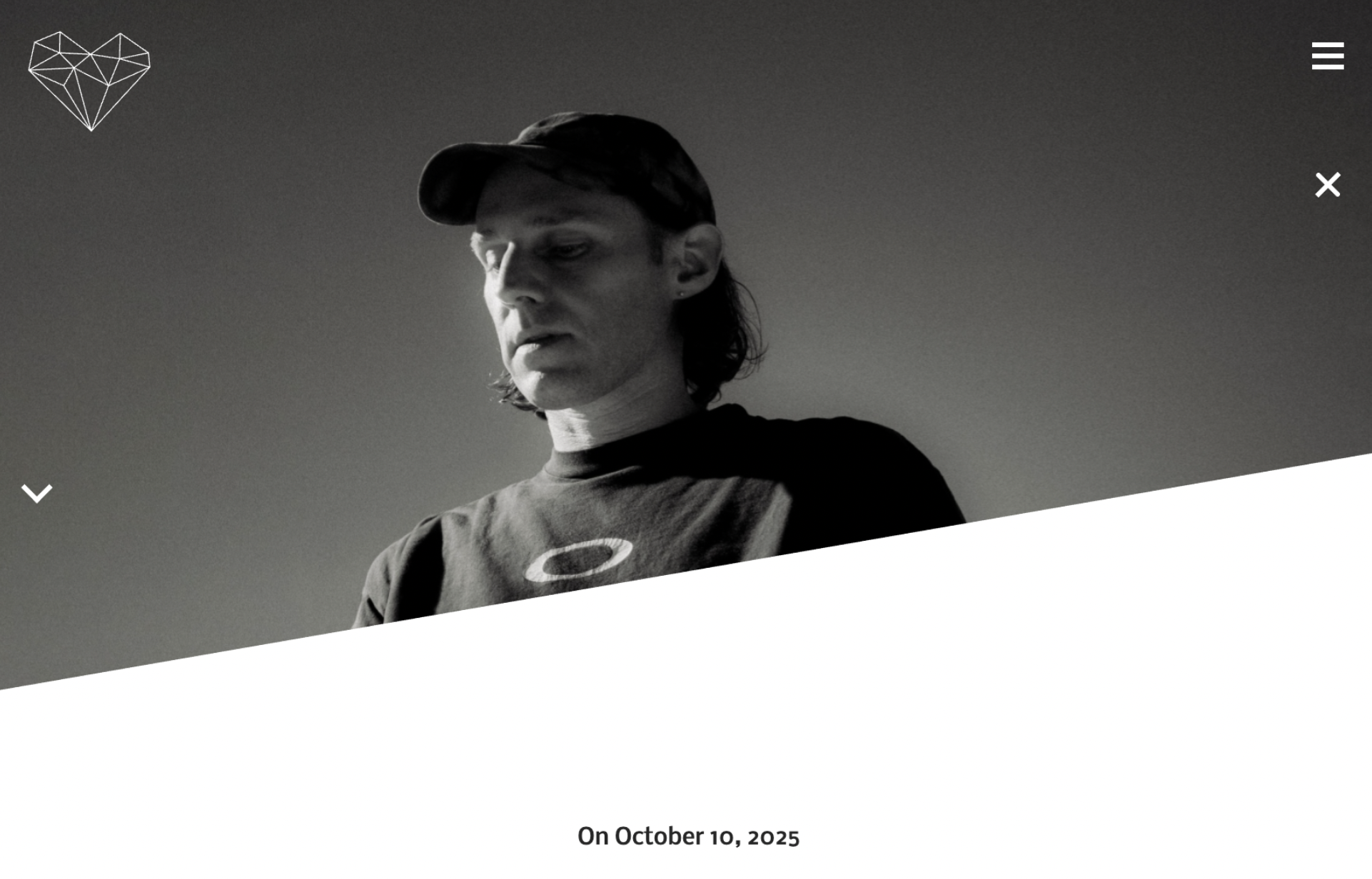 Webpage image of HMWL (House Music With Love) showing electronic musician and producer, FENRA, standing in a photo studio standing in a dark, Oakley shirt and cap.