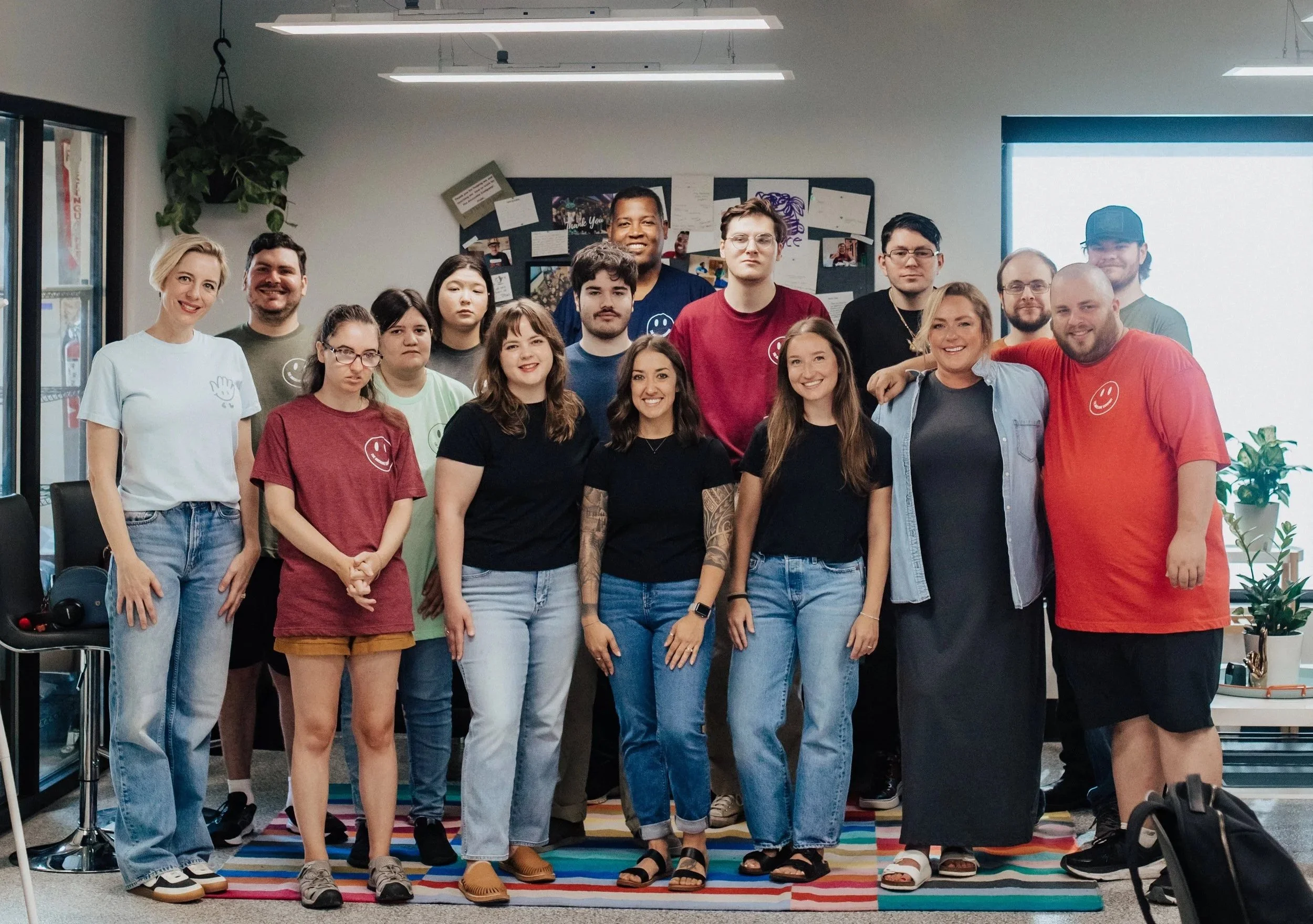 Group photo of smiling neurodivergent coworkers.