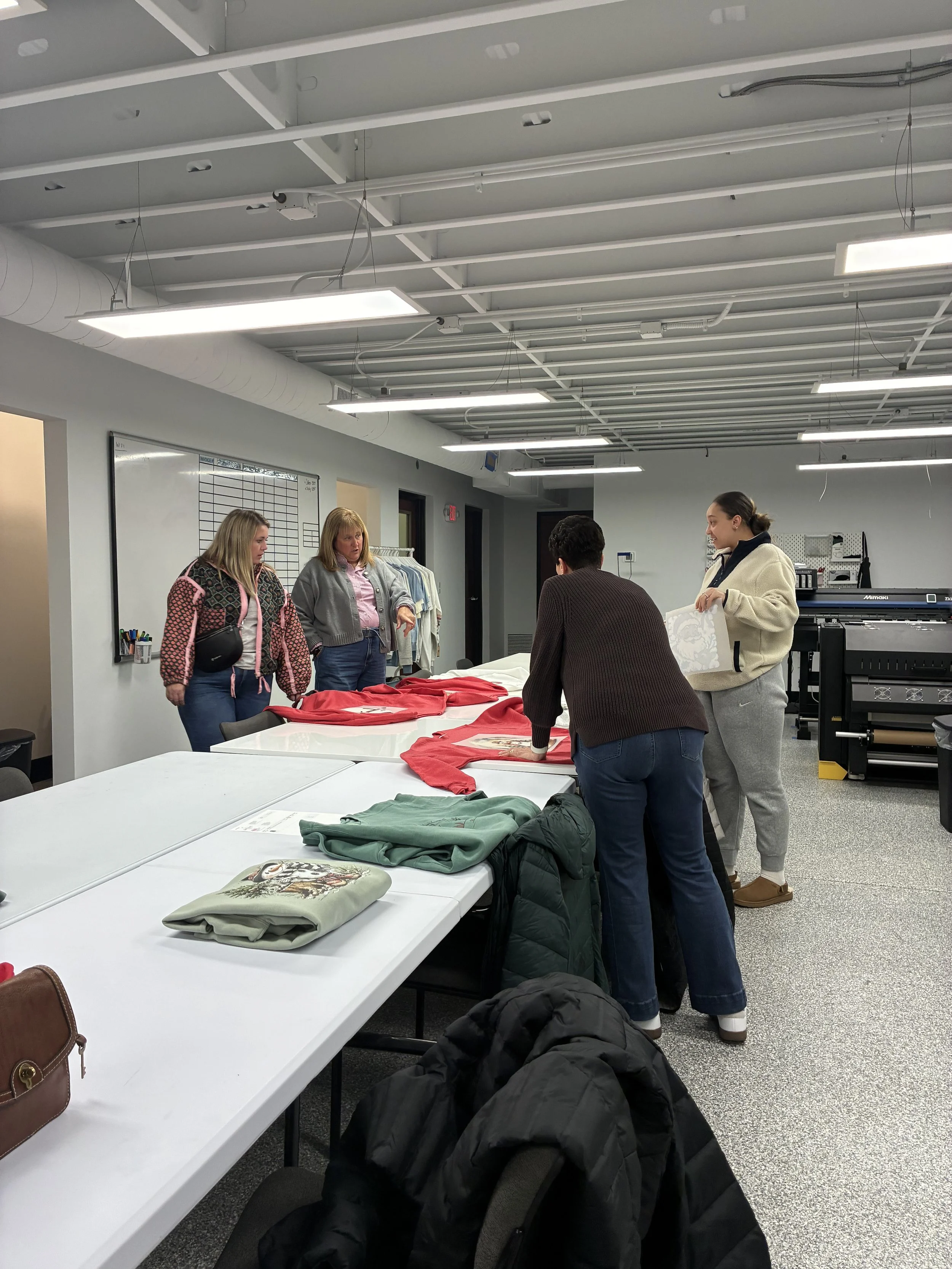 Group of guests comparing their finished custom shirts at a print party.
