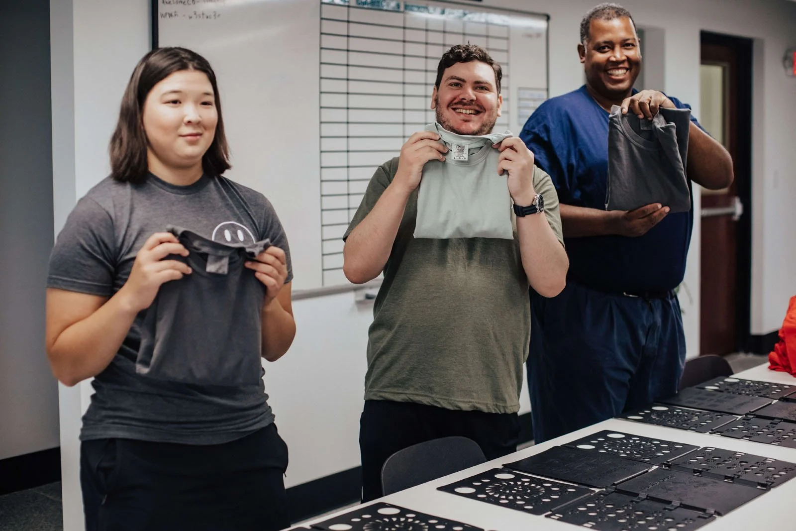 Employees smiling and glowing with pride.