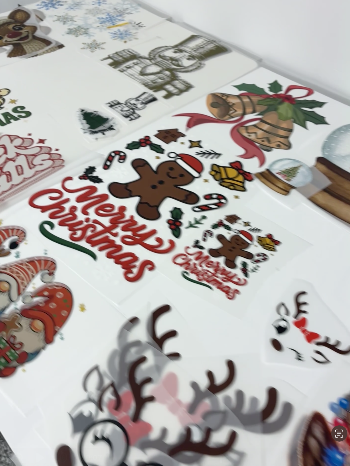 Display table of Holiday themed premade heat press designs ready for a print party.
