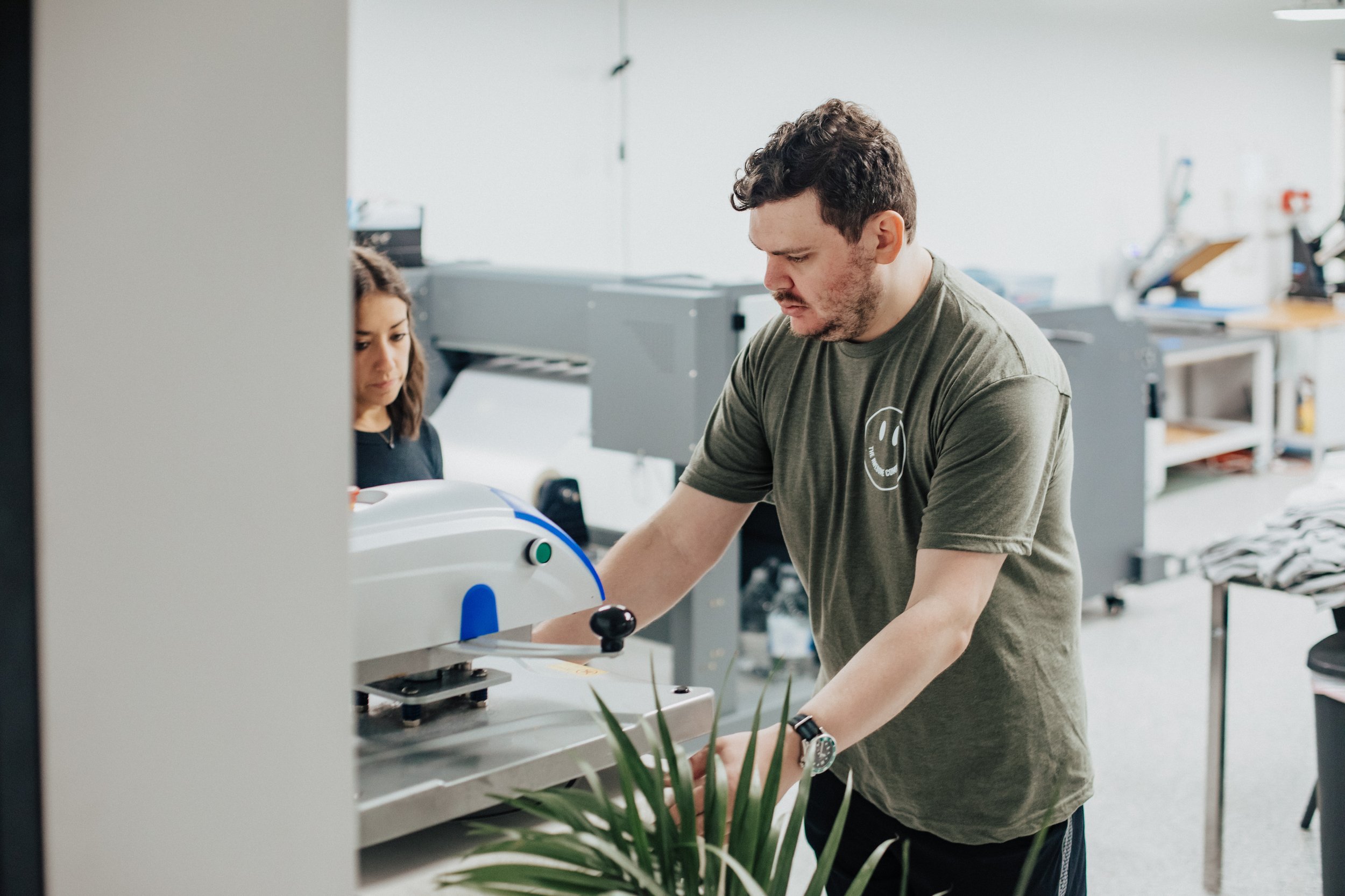 Heat press closing over a garment during transfer application.