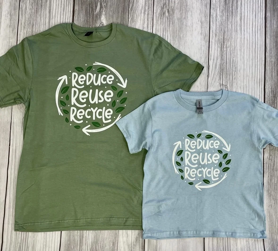 Flat lay of trendy T-shirt designs for 2025 with bold typography and minimalist artwork.