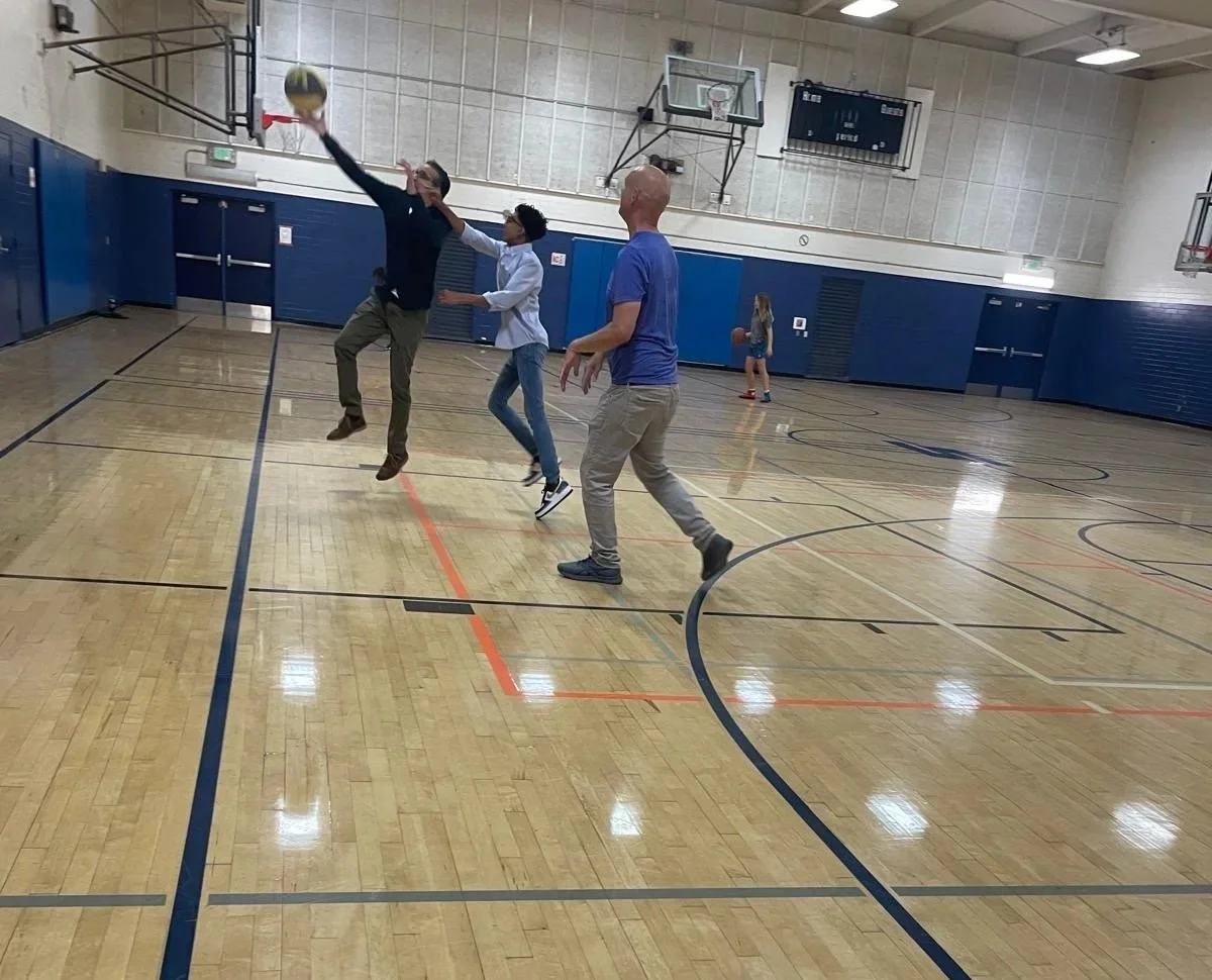 Alok Dube, MDplaying basketball in an indoor gymnasium, showing one of his hobbies and a healthy fun way to get exercise