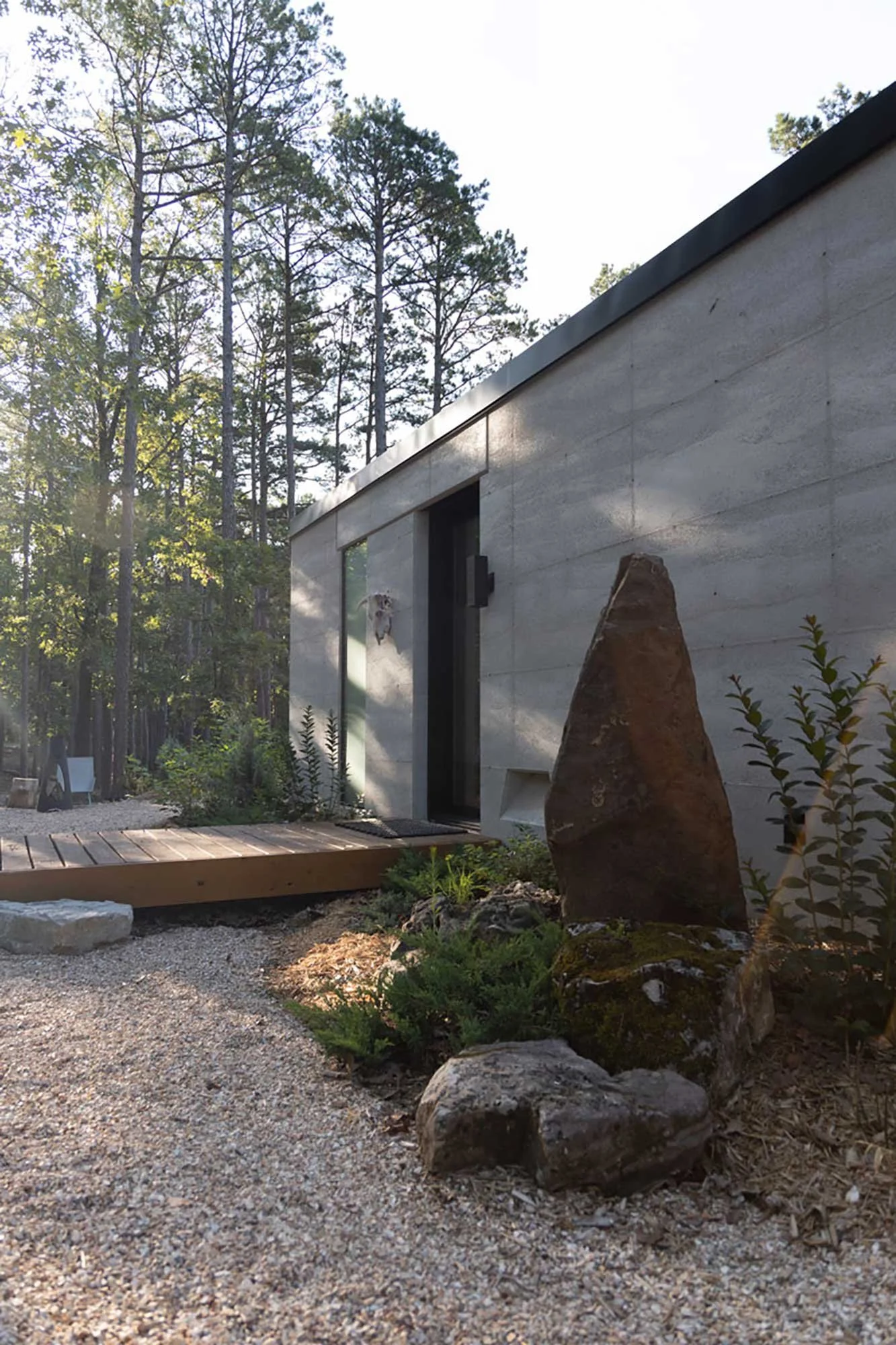 Sunset light highlighting CALX Cabin’s Rammed Earth exterior walls.