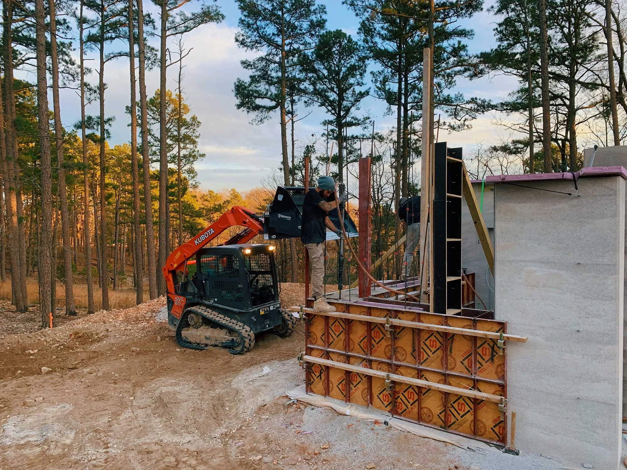 Early construction phase of CALX Cabin with Rammed Earth walls rising.