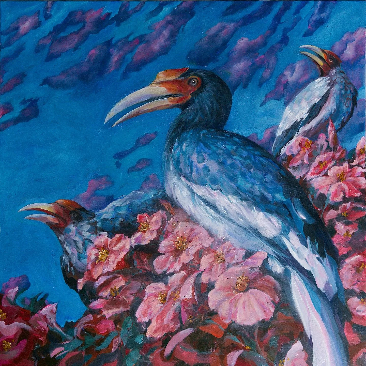 Alyona&rsquo;s art focuses on perception rather than explanation.
Hibiscus Watchers &mdash; oil on canvas. Three hornbills rise from a field of hibiscus against a saturated blue sky, translating a memory of Malaysia into color, movement, and atmosphe