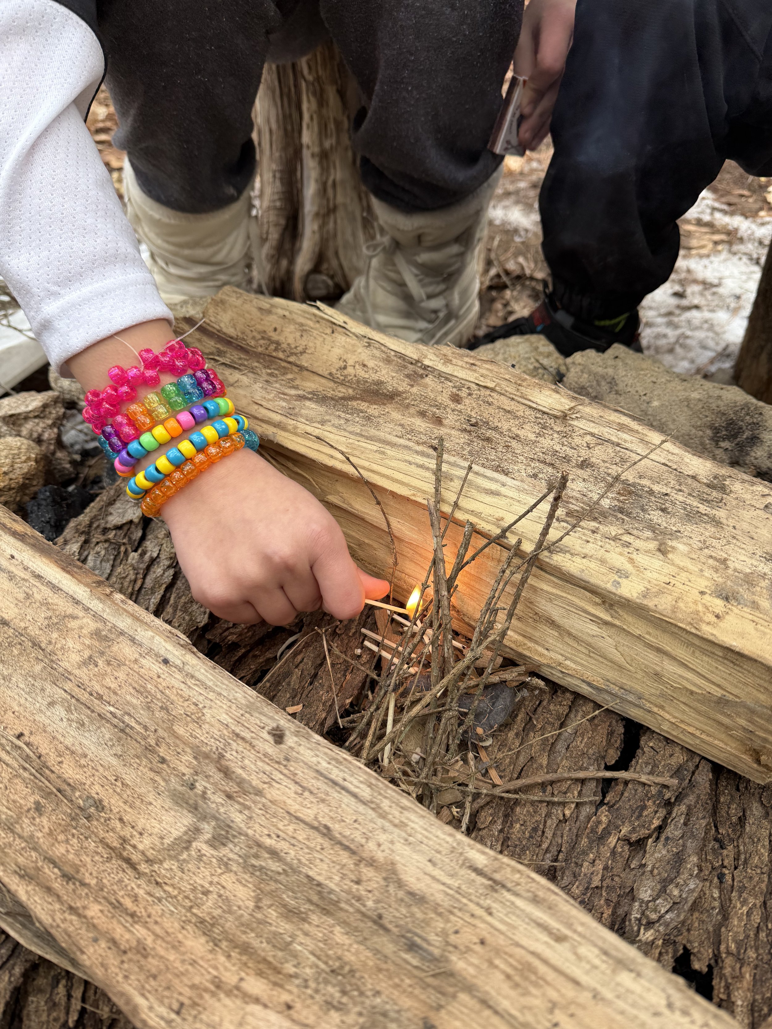 Children working together to build a fire