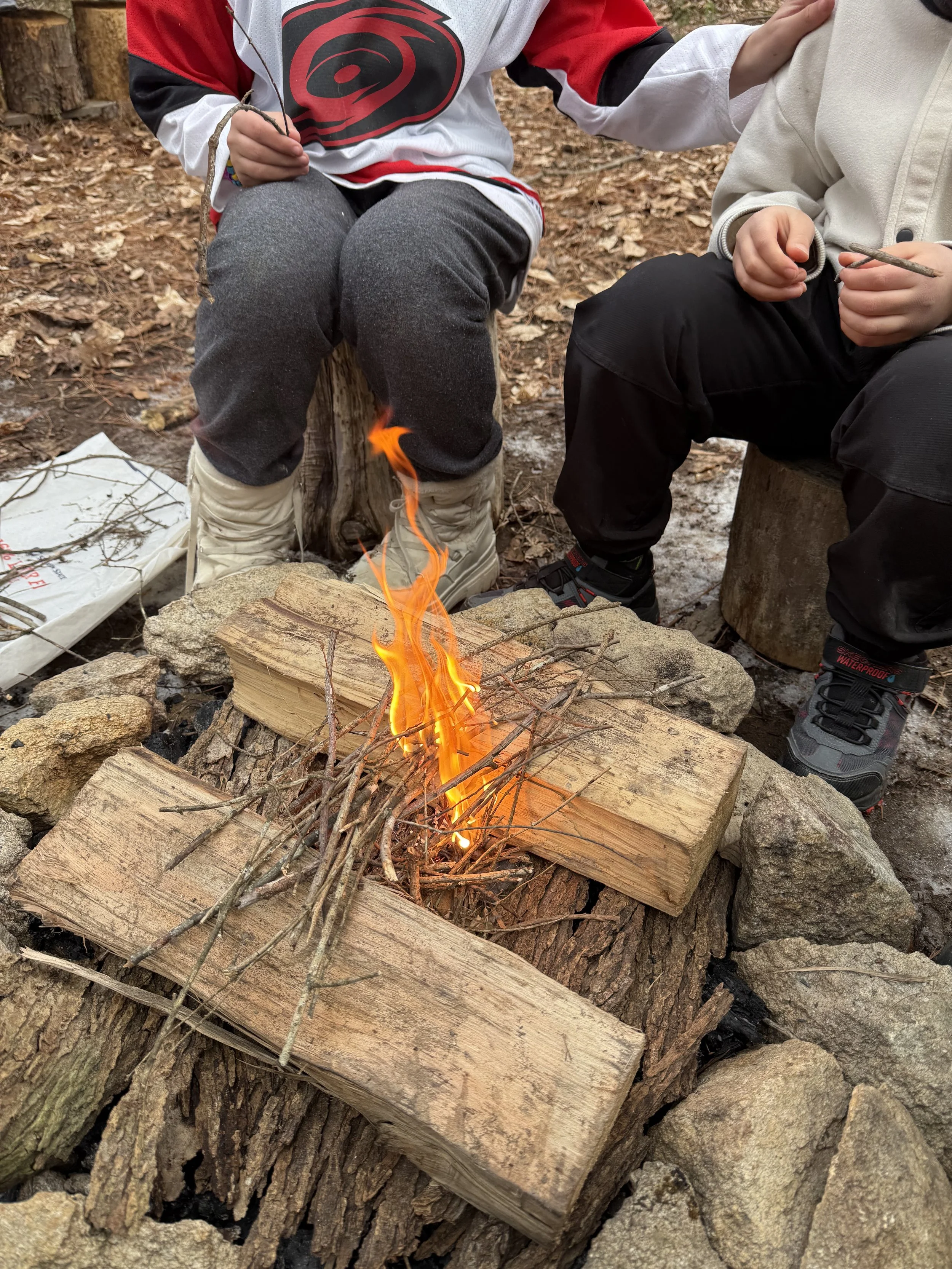 Children working together to build a fire