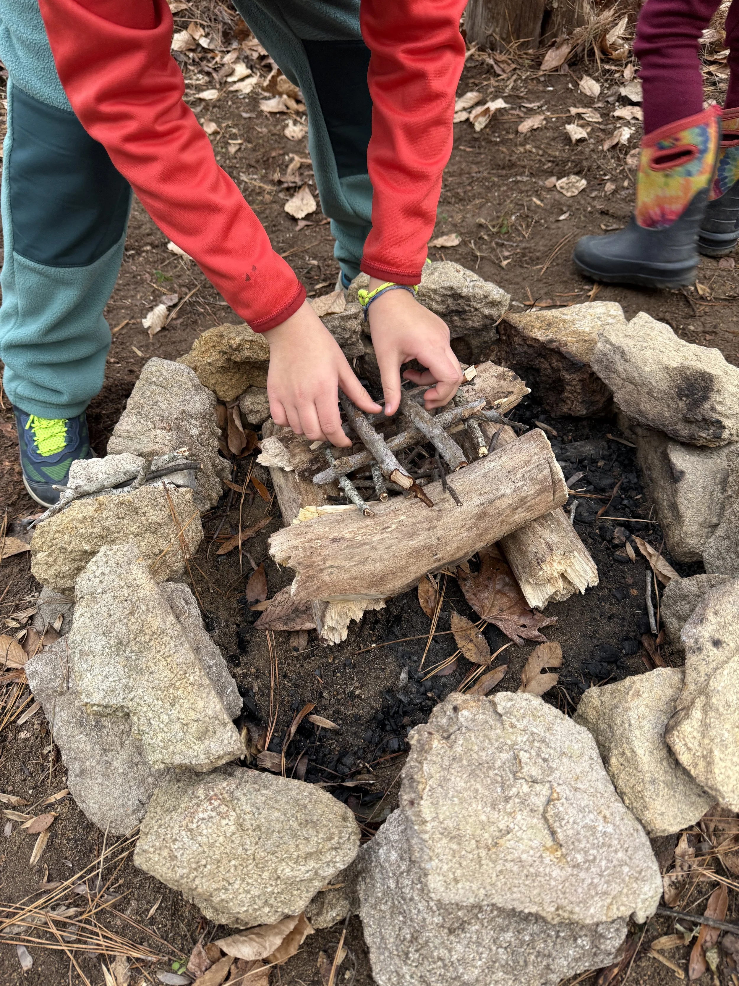 Children working together to build a fire