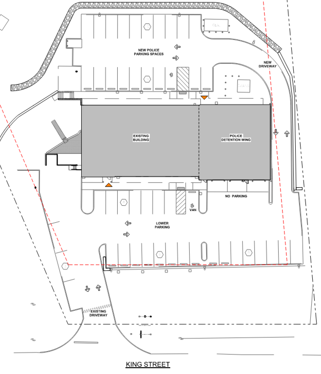 Site plan of a police station with marked parking areas, new police parking, lower parking, no parking zone, existing driveway, new driveway, police detention wing, existing building, and a van space. Located on King Street.