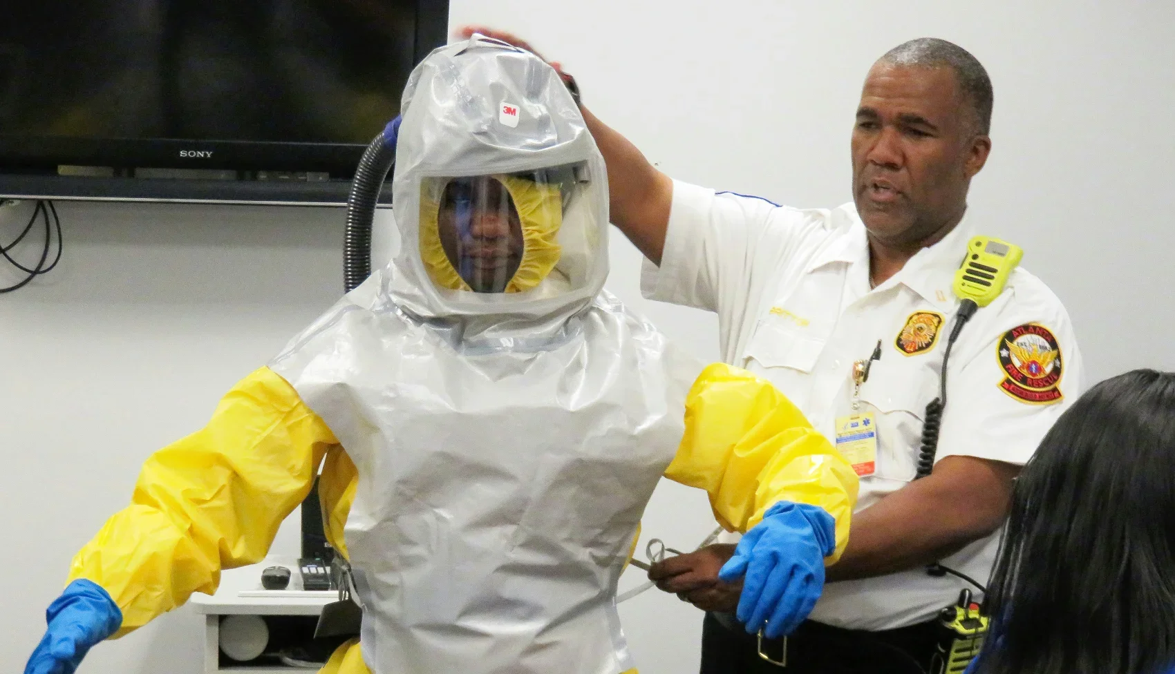 Fire safety officer teaching PPE usage