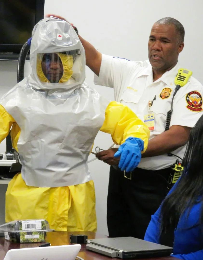 Fire safety officer teaching PPE usage