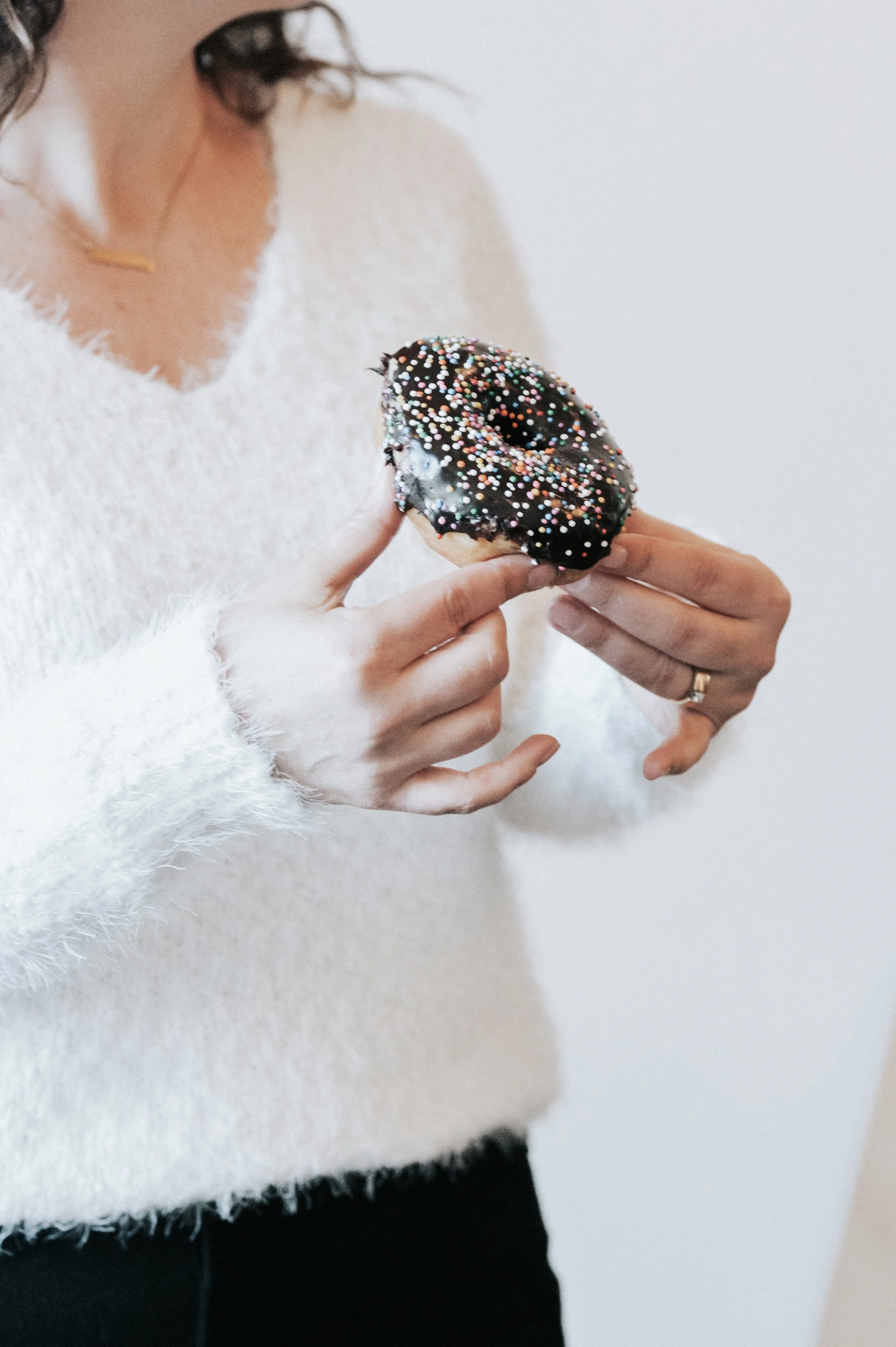 woman holding a donut