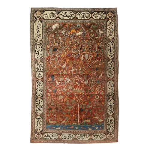 MOHTASHAM KASHAN 'TREE OF LIFE' MEDITIATION RUG 
c. 1900, wool and silk, the rust ground with entwined flowering trees, animals, and birds engaged in various activities, before a body of water with fish and ducks, surrounded by an Arabic text border