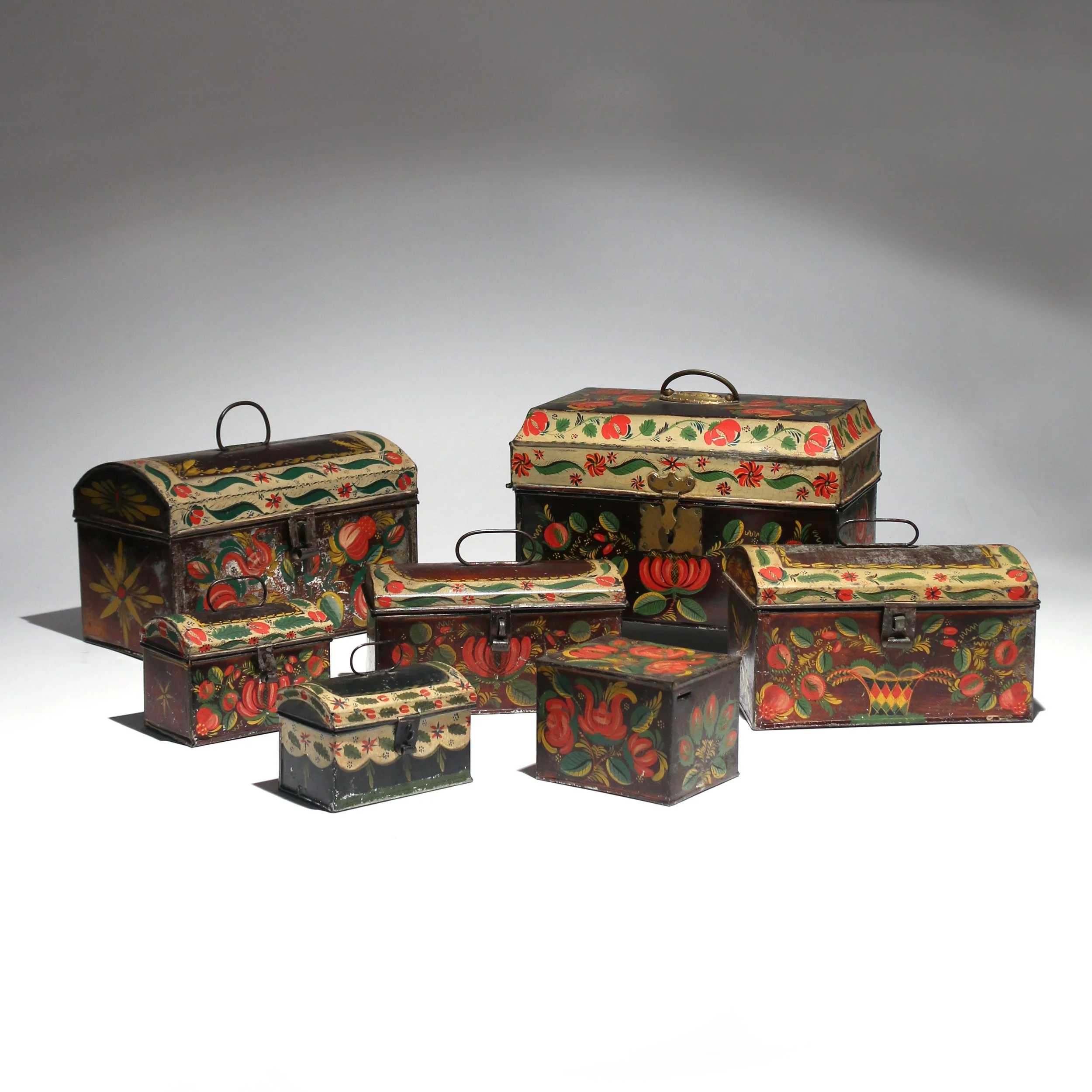 Set of vintage painted tins with floral and fruit designs.