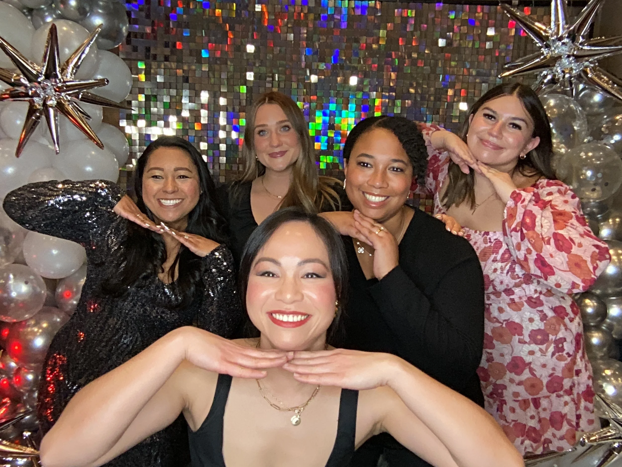 Five girls enjoying the photo booth at their Edmonton holiday party
