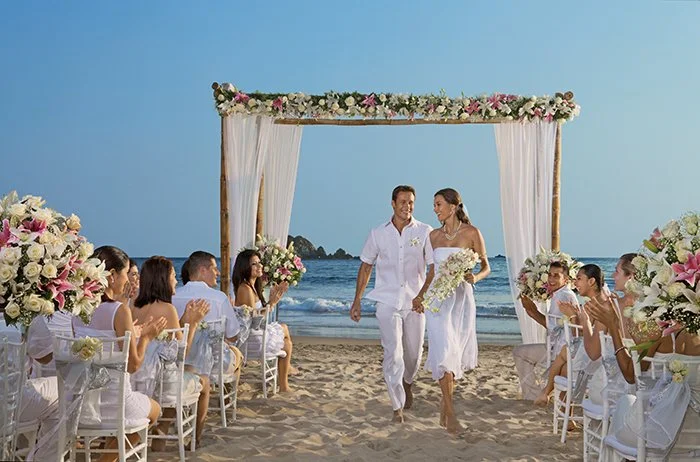 Wedding couple walking the aisle at a Puerto Vallarta beach.