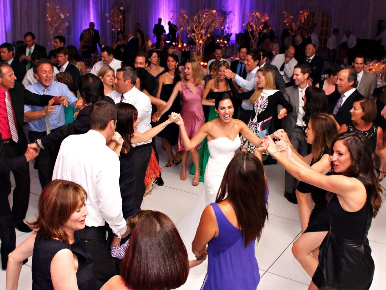 Bride dancing and smiling at wedding reception