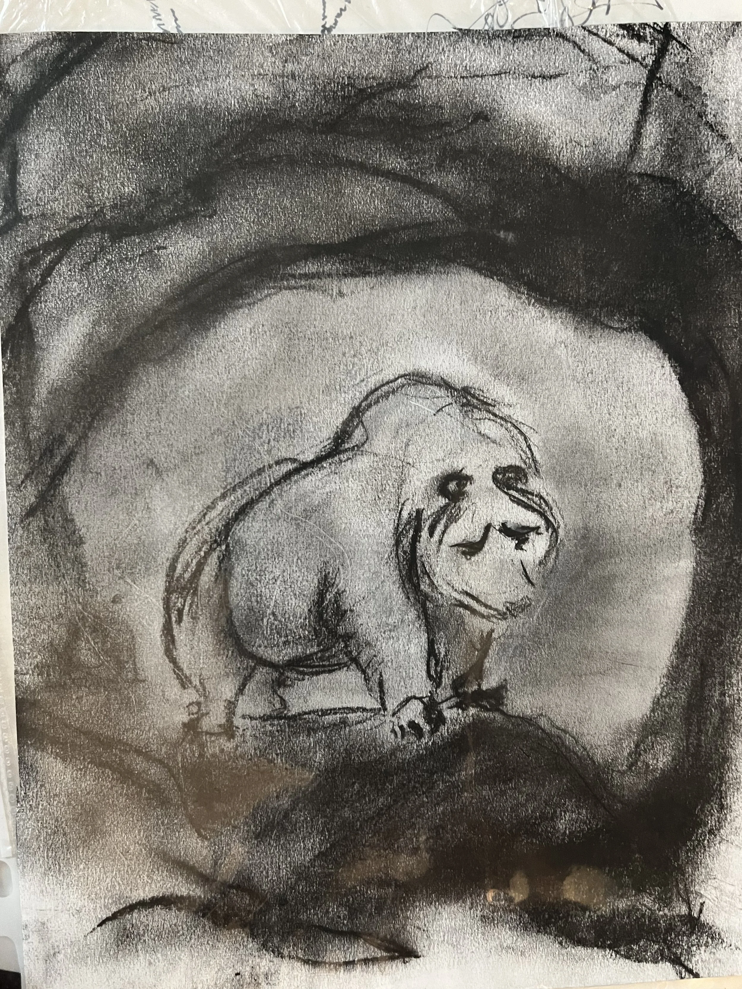 A charcoal sketch of a dog with long, floppy ears, sitting on a surface with its head lowered and eyes closed, surrounded by abstract dark and light shading.
