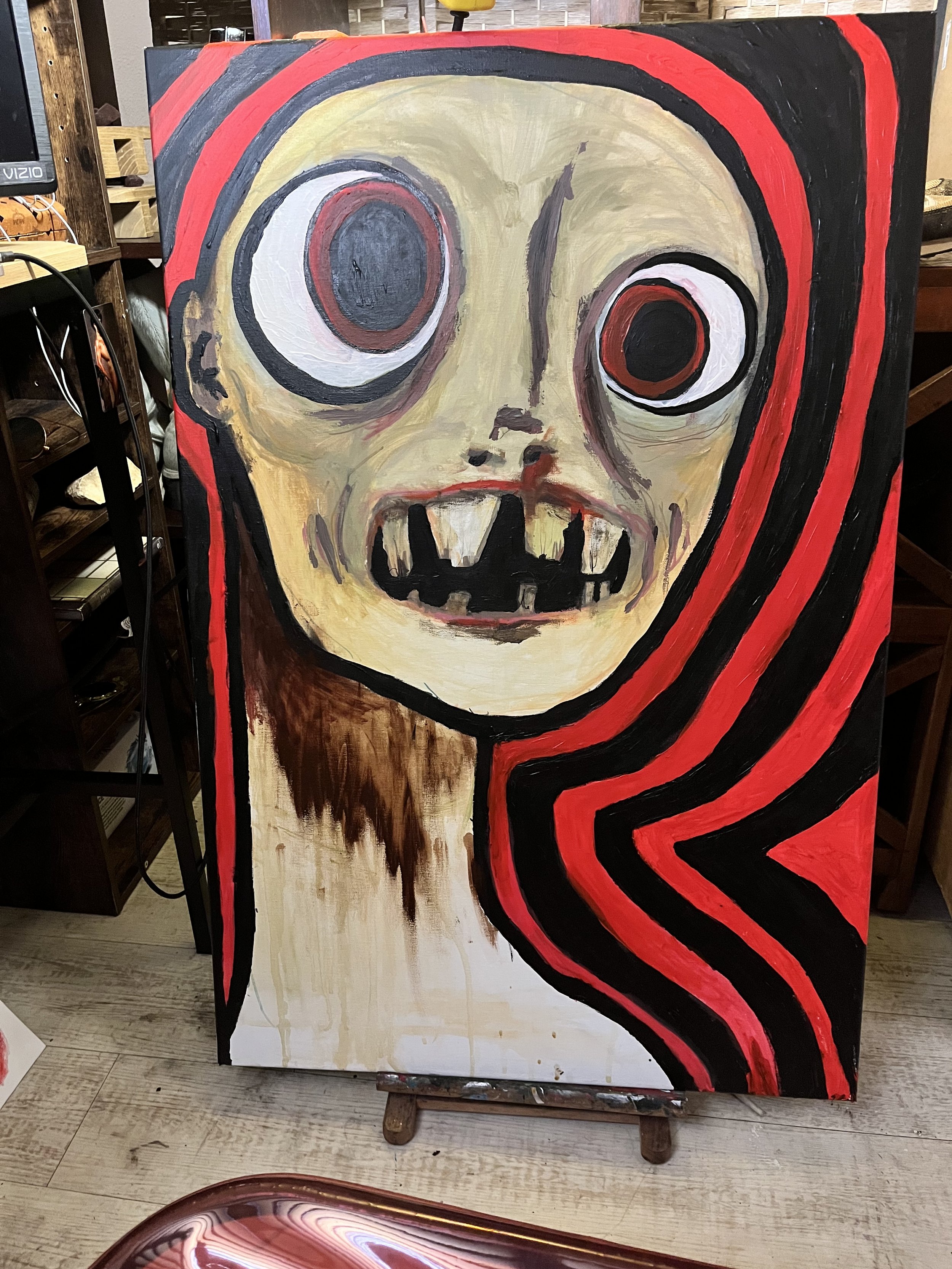 A painting of a creepy skull face with large, uneven eyes, sharp teeth, and a dark brown neck. The background and surrounding areas have red, black, and beige colors, with a red and black striped pattern flowing from the right side of the skull.