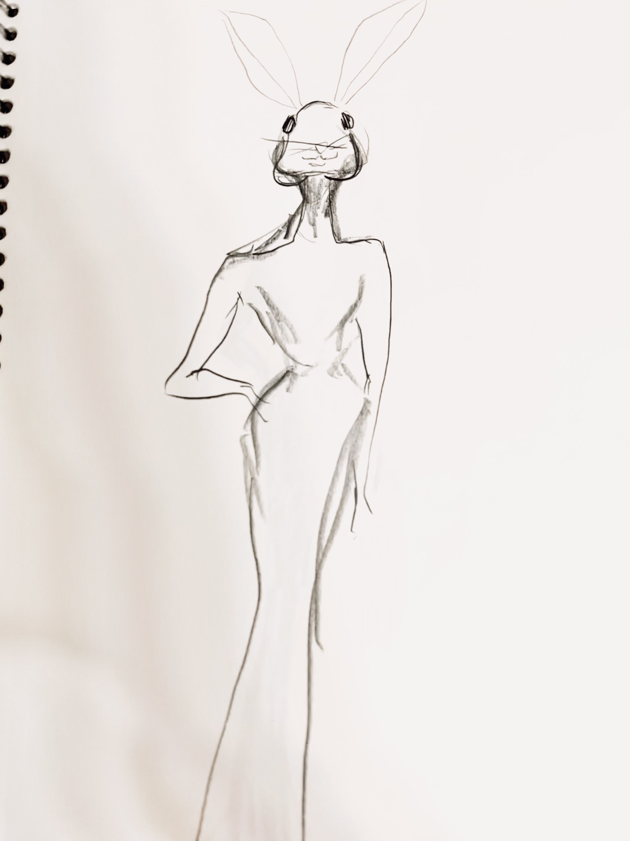 A sketch of a humanoid figure with the head of a rabbit, featuring large ears, and a human body with one hand resting on the hip, dressed in a long, form-fitting gown.