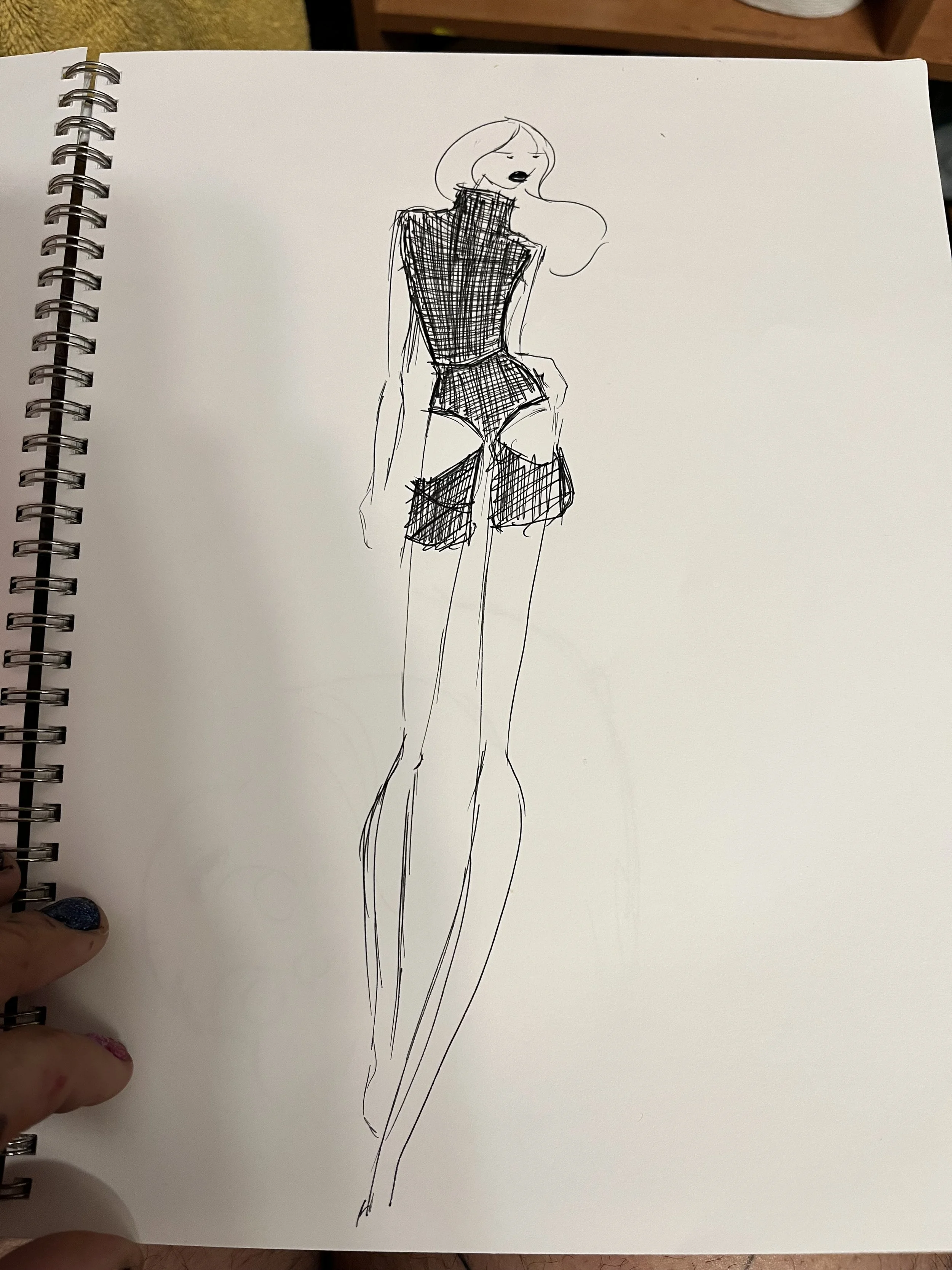 Fashion sketch of a tall woman with long legs, wearing a high-neck sleeveless top and shorts, with a handbag, drawn in black ink on white paper.