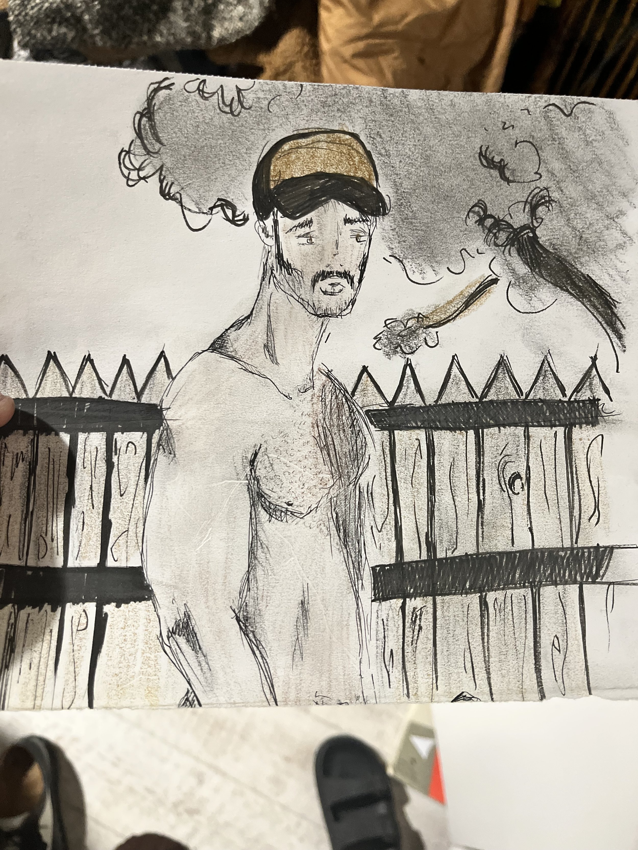 A black and white sketch of a shirtless man with a beard and mustache, wearing a cap. He appears to be sad or tired, with a background of smoke, clouds, a falling object, and a fence.