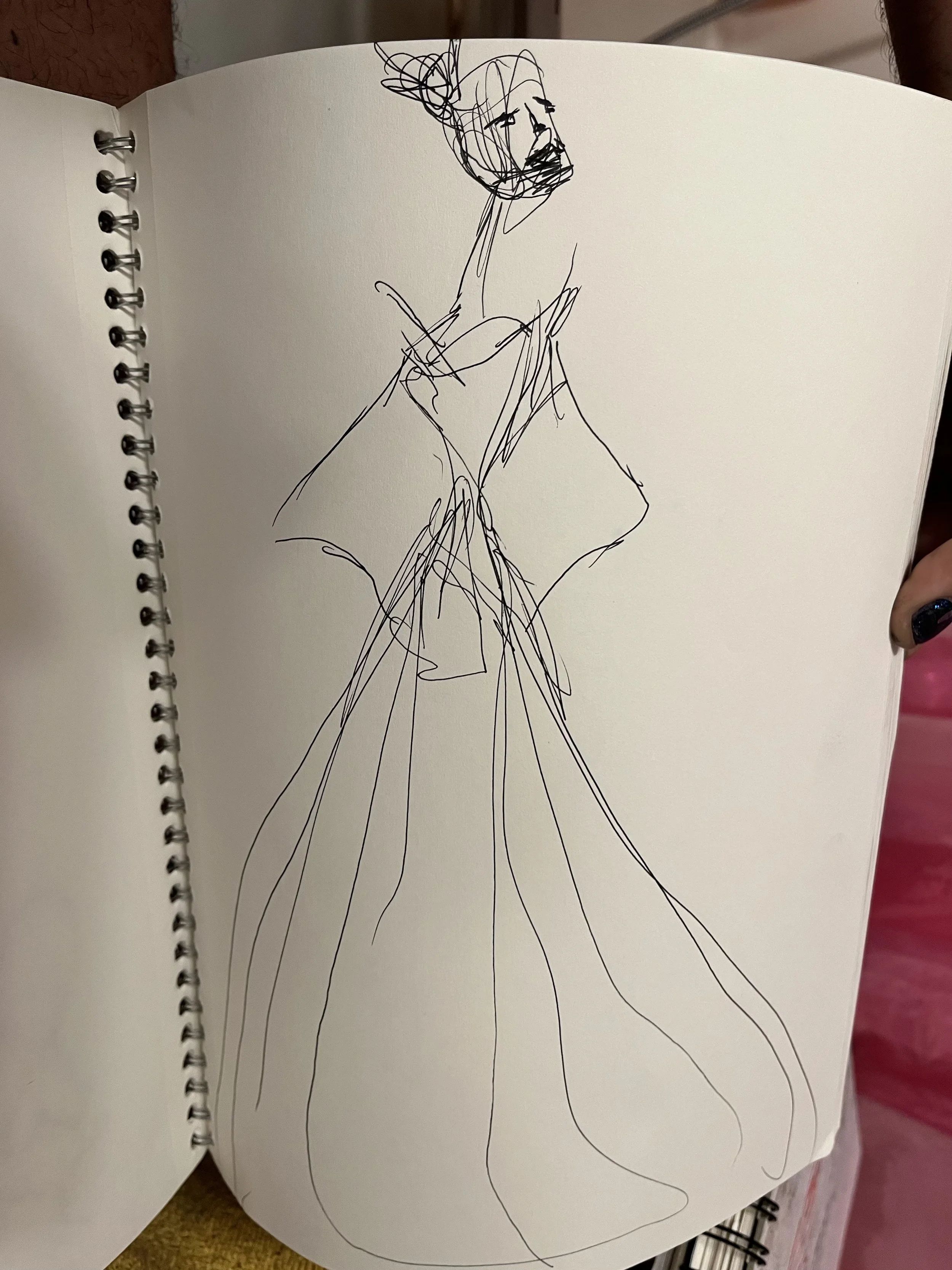 A sketch of a woman in a flowing dress with a bun hairstyle and a beard, drawn with loose, quick lines.