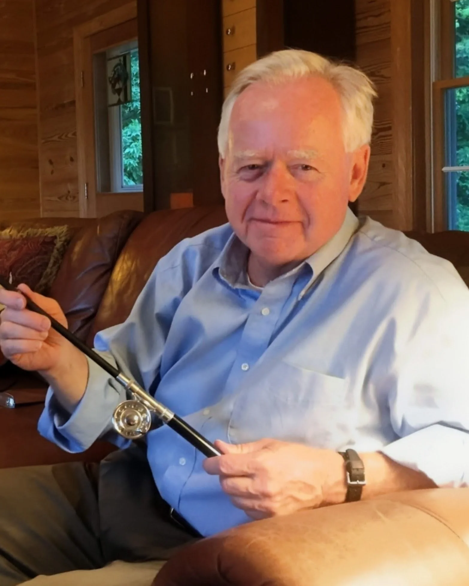 A picture of attorney Chuck Lacy holding a fishing pole and smiling