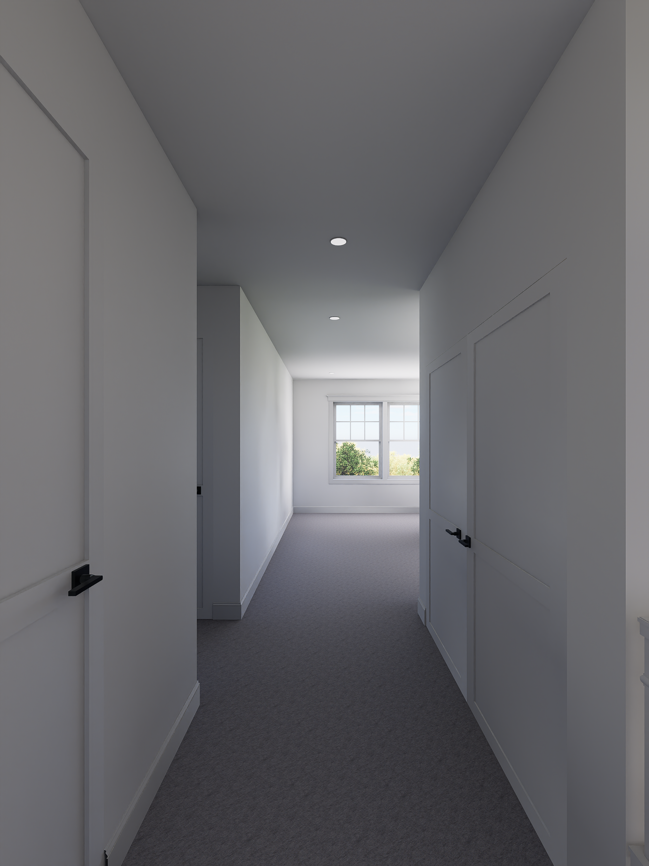 A hallway in a modern home with white walls, gray carpet, and a window at the end showing trees outside.