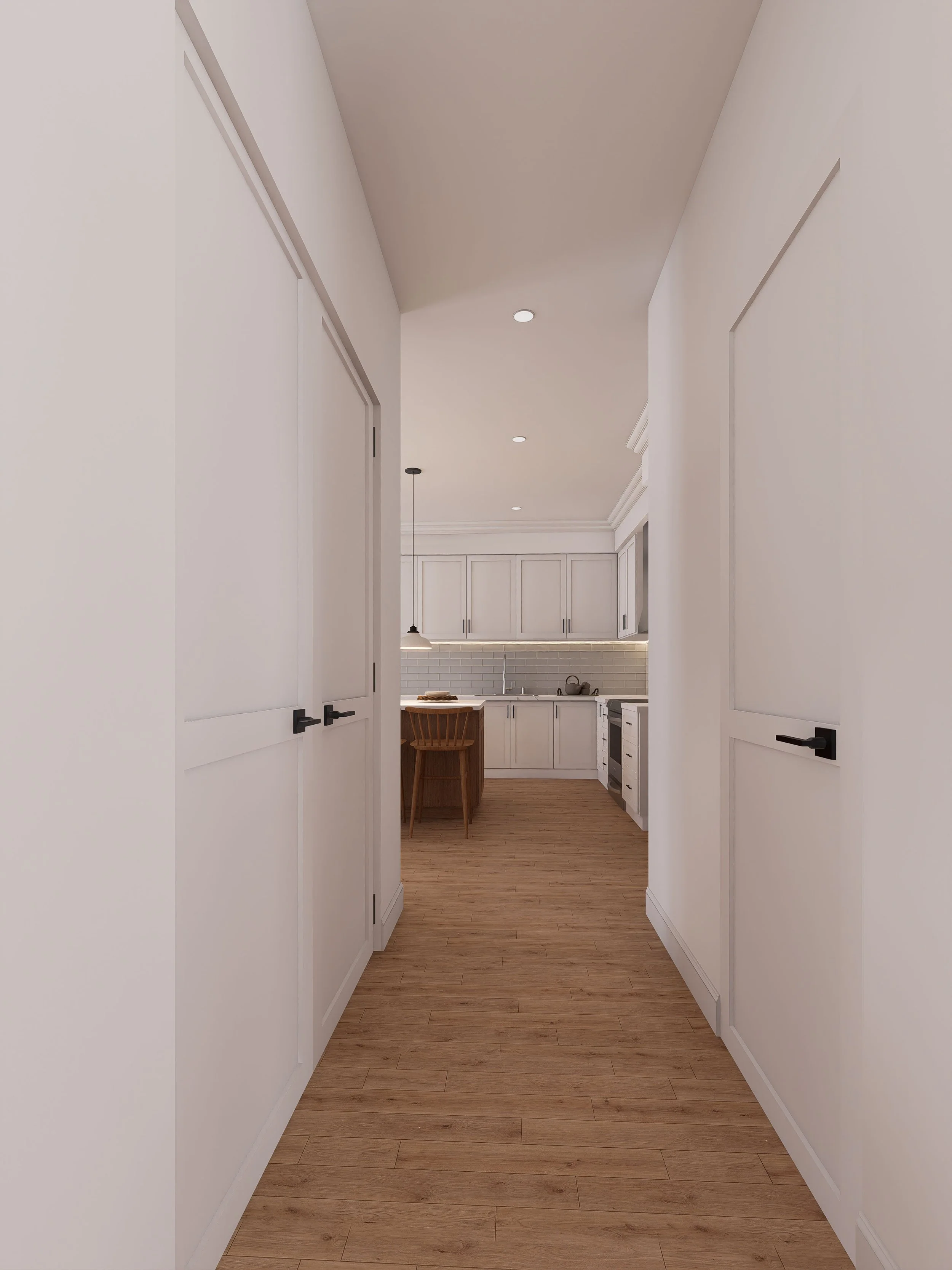 View of a hallway leading to a kitchen with white cabinets, a wooden dining table, and wood flooring.