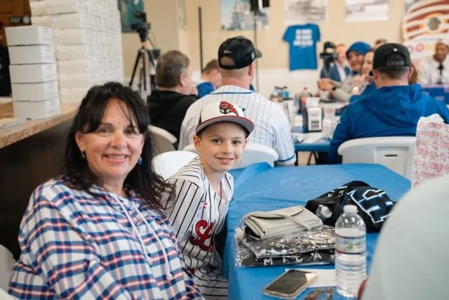Mom and son at a baseball-themed event with Mike Trout