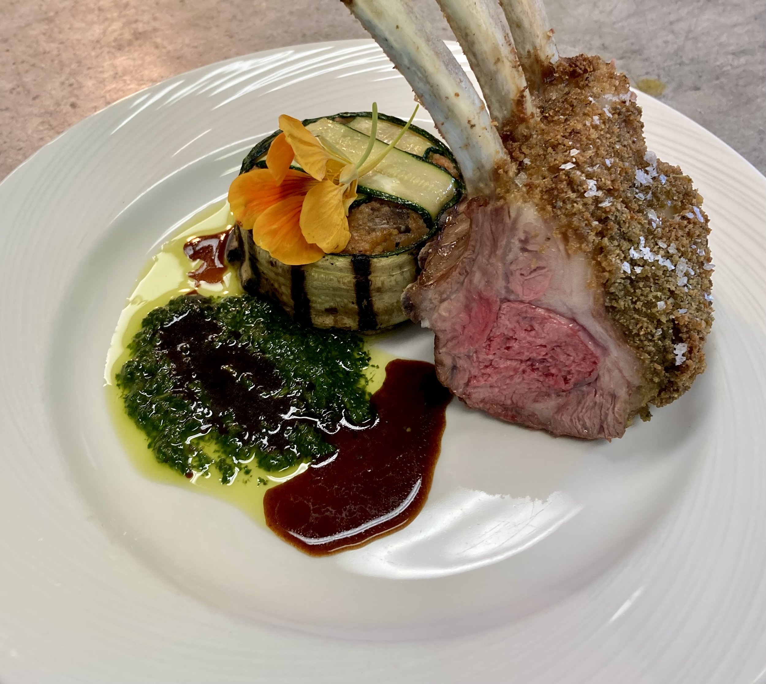 Dehydrated olive crusted rack of lamb, cous cous, chermoula, demi-glace