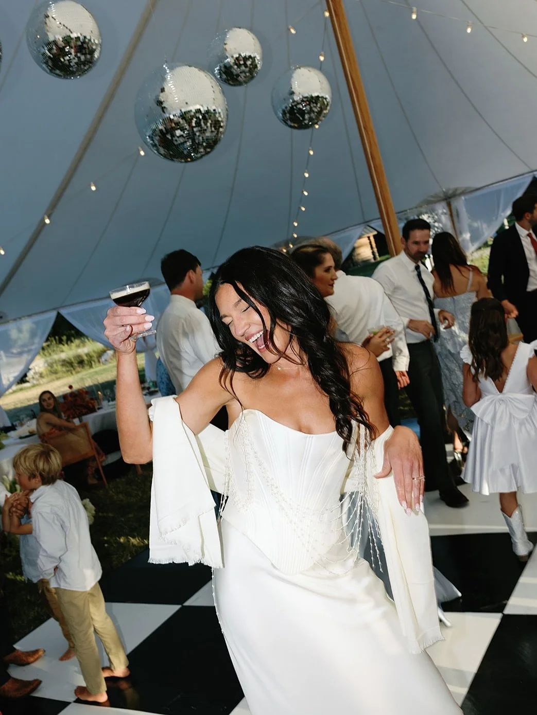 On the black and white checkered dance floor, under disco balls, a drink in hand &mdash; truly the best way to party the night away in style. 

2026 brides, are we keeping the disco ball trend alive next year? 🪩✨

Wedding Planner: @olivawillowdesign