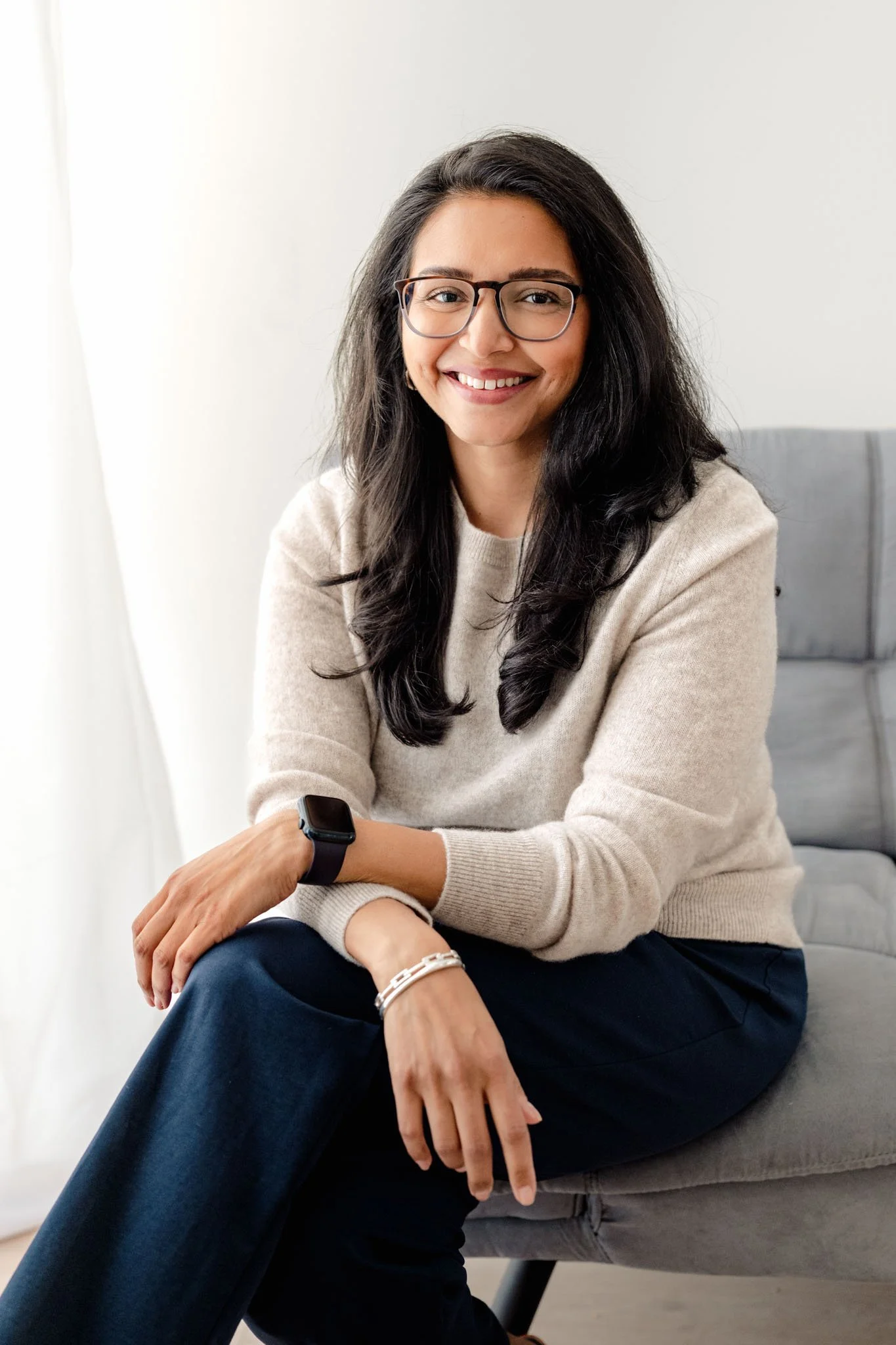 Headshot of Dr. Roshni Patel in a beige sweate smiling at the camera