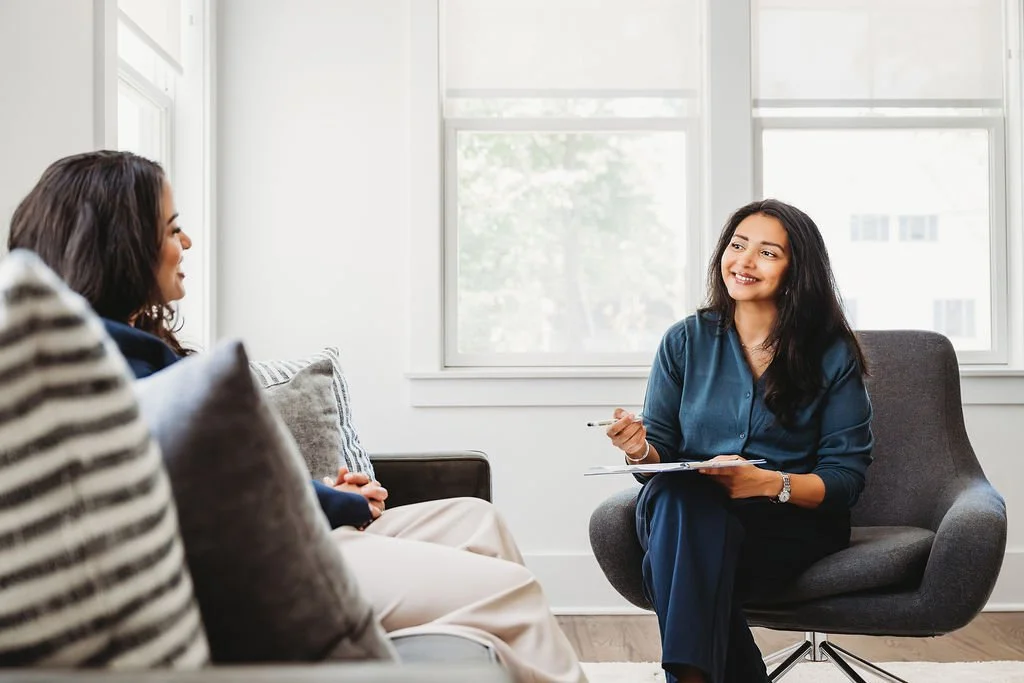 Dr. Roshni Patel smiling and conversing with a patient
