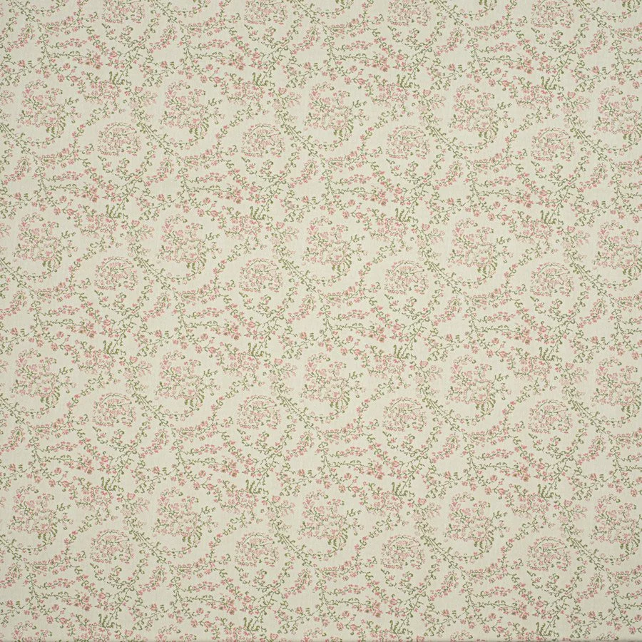 A fabric with a cream-colored background and a floral pattern in pink and green, arranged in a repeating diamond and swirl design.