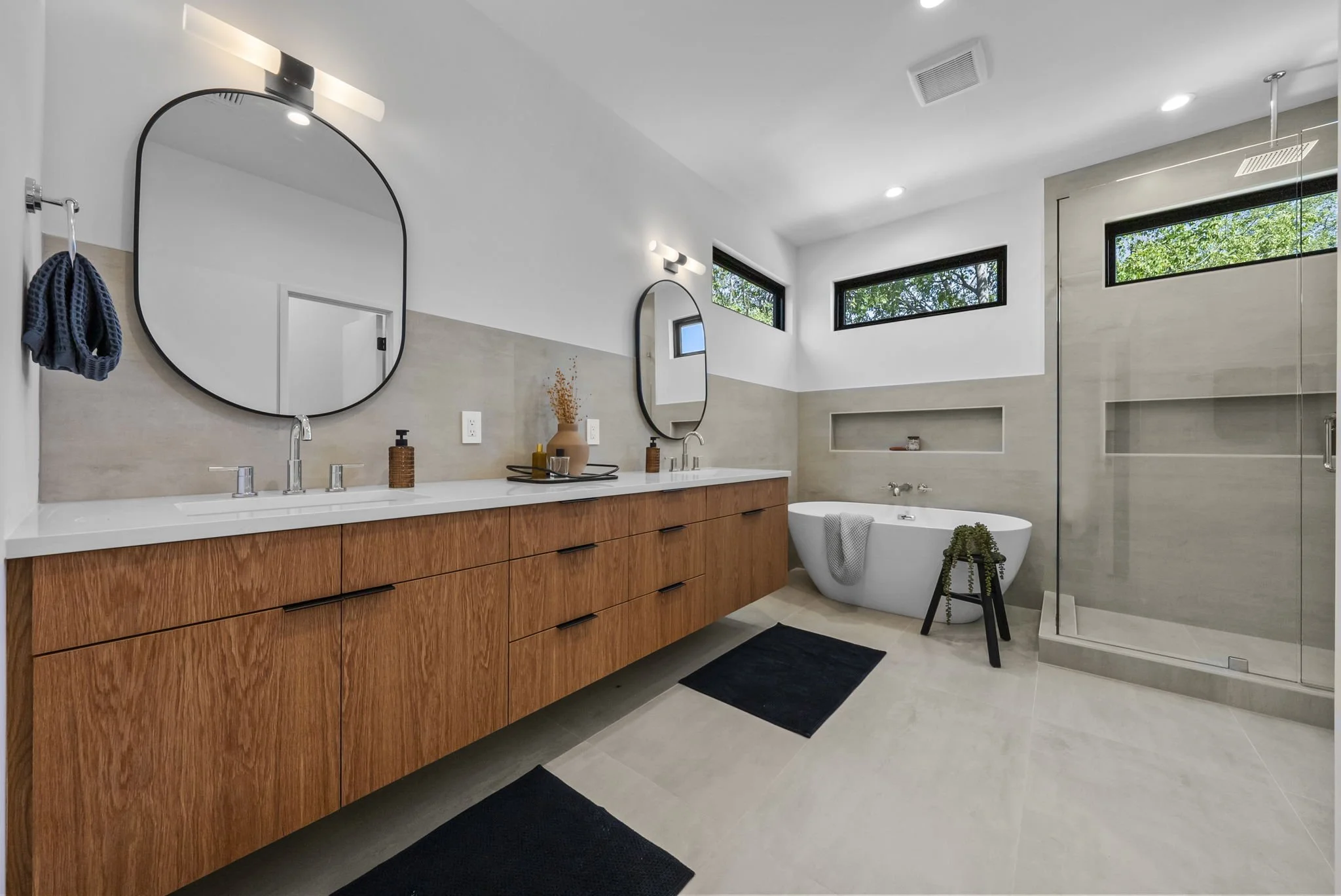 Primary bath with dual vanities, soaking tub and spa shower
