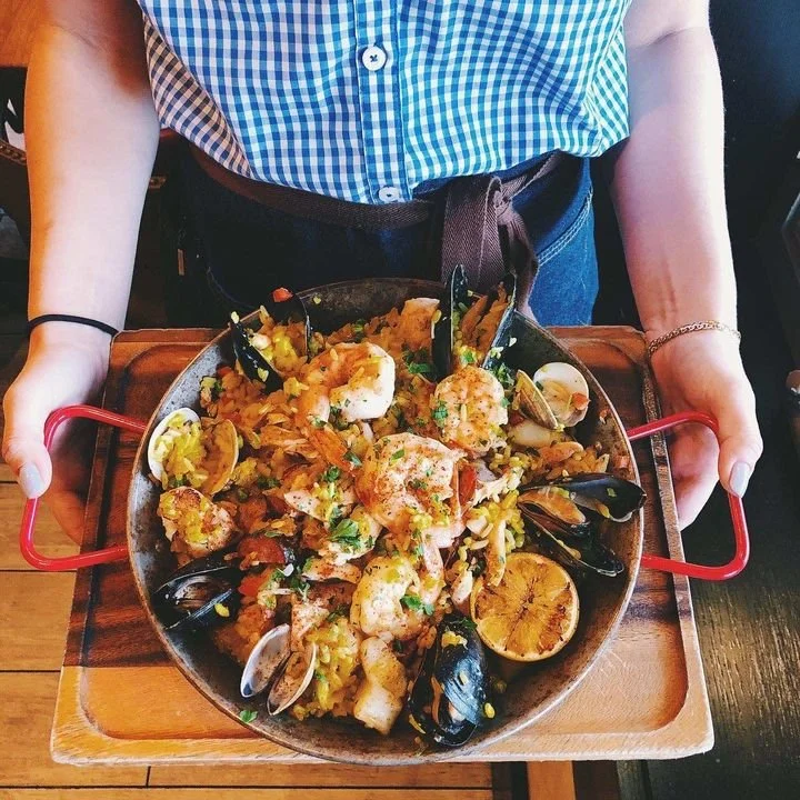 Spanish Paella in a paella pan made with St Ours Clam or Crab Broth