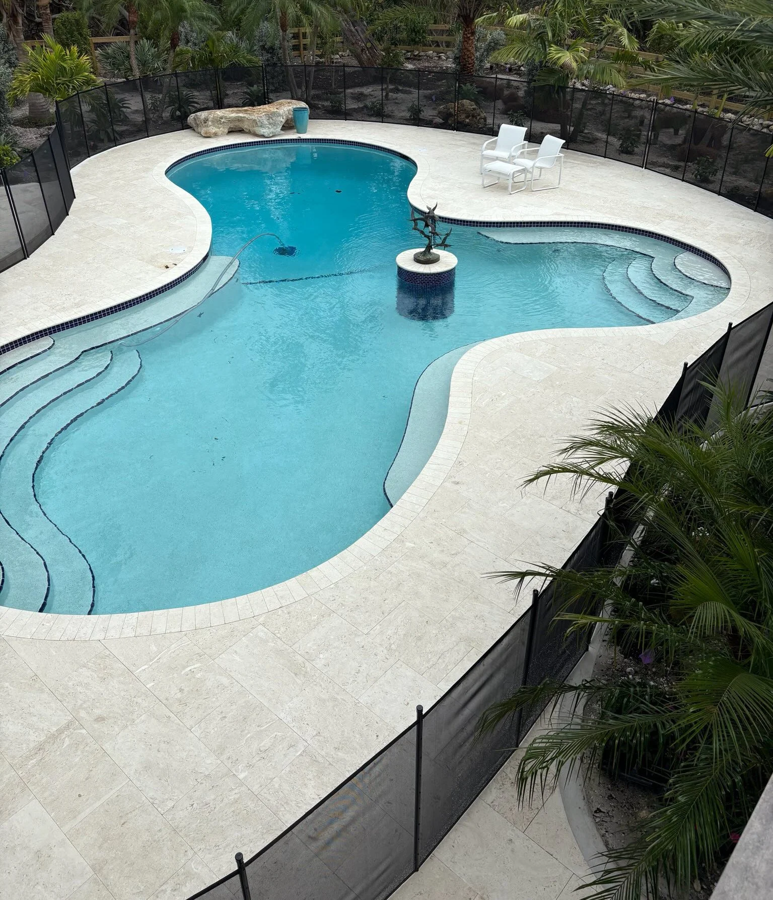 Elegant pool area protected by Lifeguard Pool Safety Fence