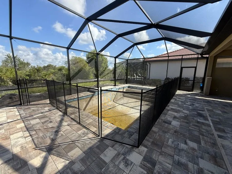 Backyard pool area after pool safety fence installation