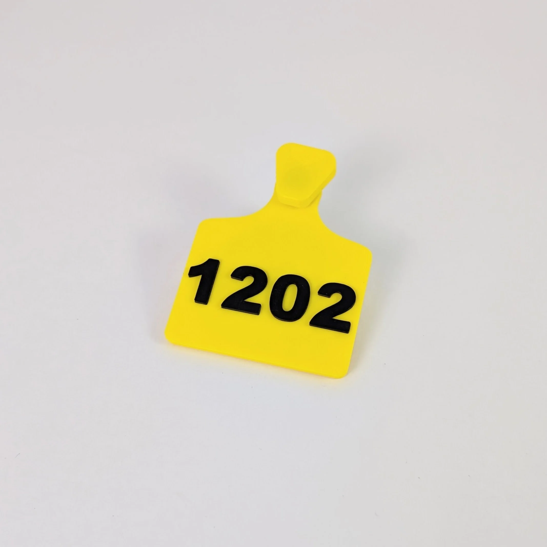 Yellow Fursuit ear tag with black text