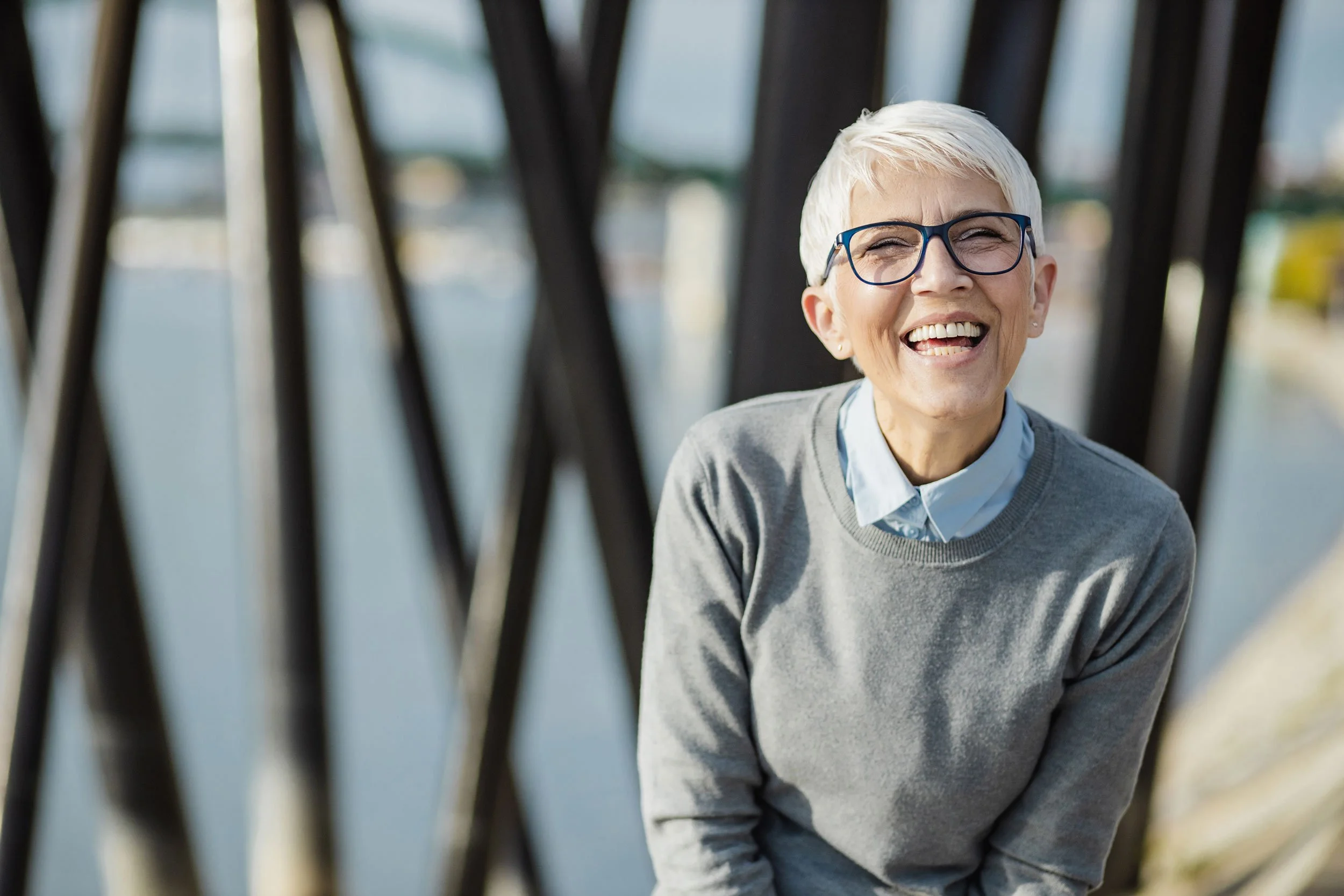 Smiling older person in grey sweater