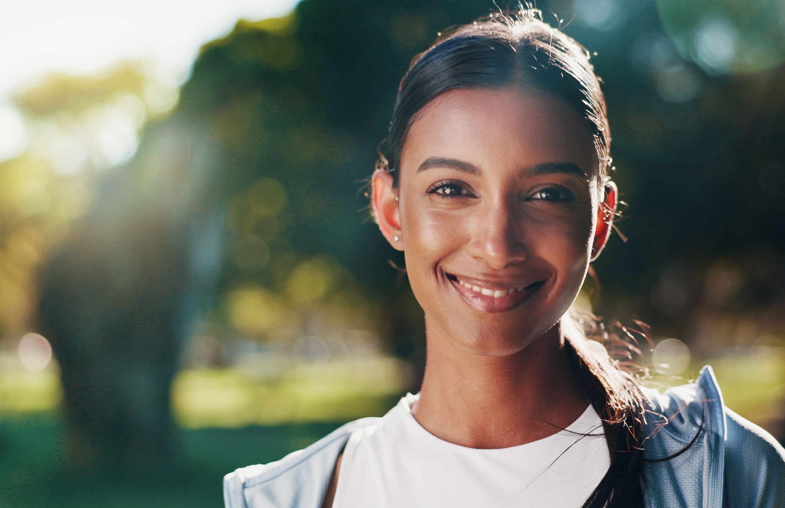 South Asian woman smiling outside