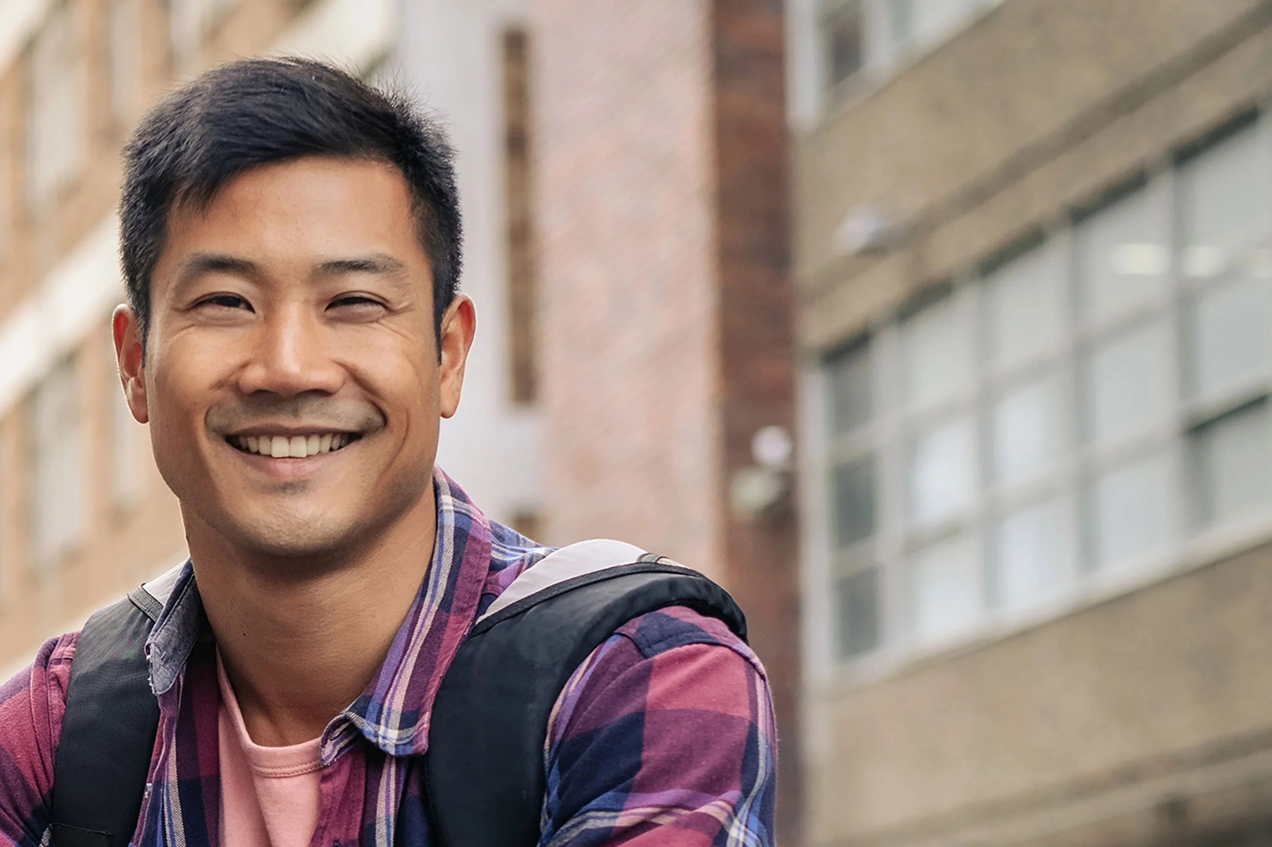 smiling asian guy in street scene