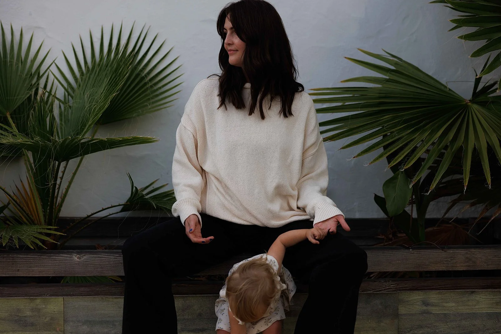 woman and infant with palms